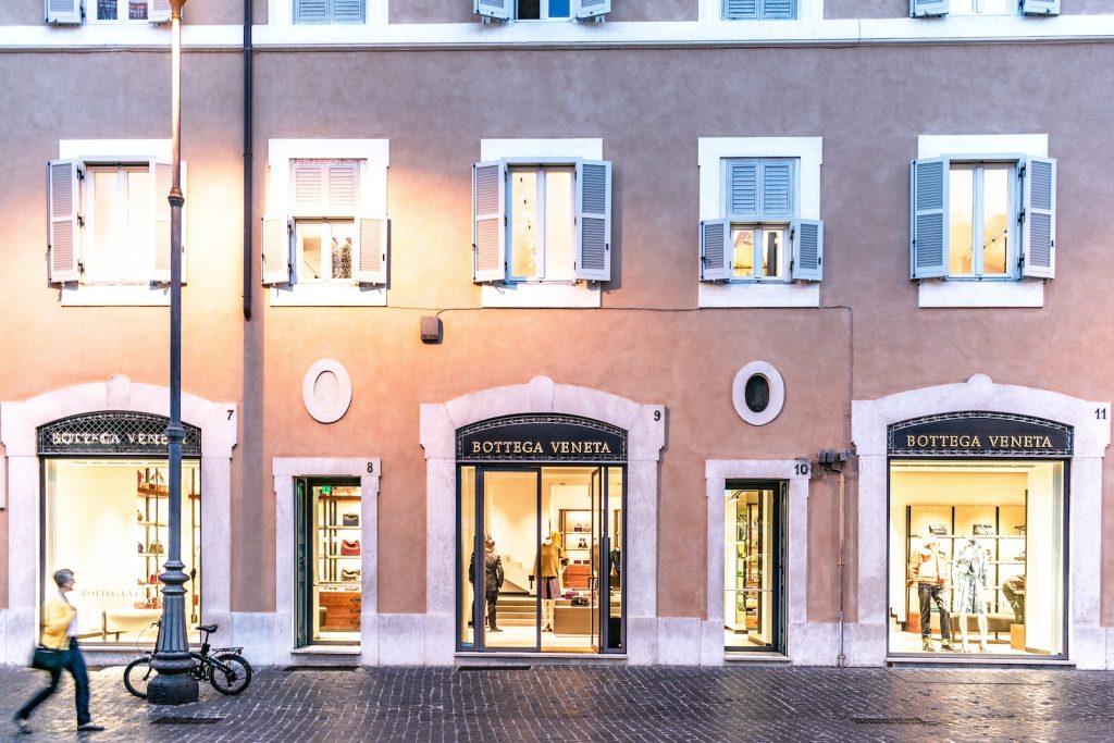 person walking on the sidewalk beside the building