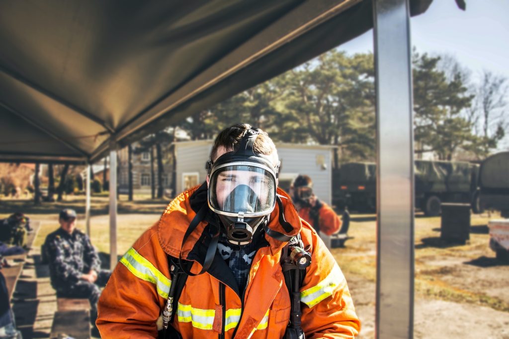 shallow focus photography of firefighter in full suit